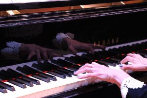 Instructor Katy playing piano